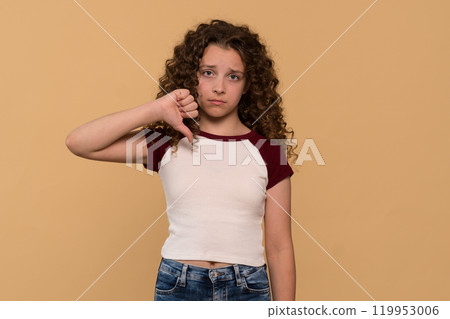 Young girl giving thumbs-down gesture, showing disapproval Young girl giving thumbs-down gesture, showing disapproval 119953006