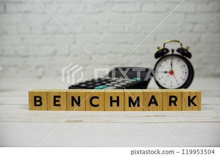 Benchmark with wooden blocks alphabet letters and calculator, alarm clock on Benchmark with wooden blocks alphabet letters and calculator, alarm clock on 119953504