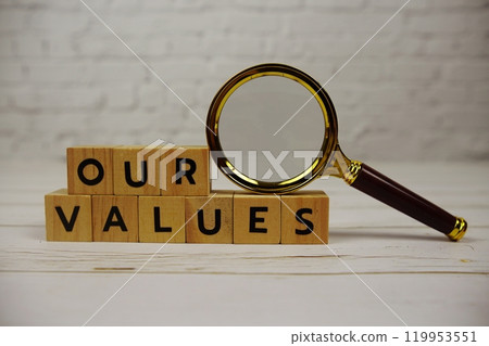 Our Values with wooden blocks alphabet letters and magnifying glass on wooden background 119953551