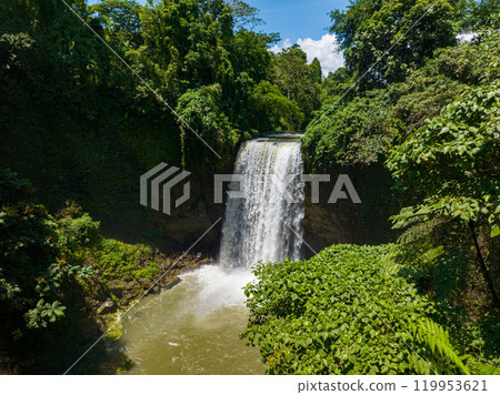 Aerial view of waterfall in Lake Sebu. Falls surrounded by lush vegetation and towering mountains. Mindanao, Philippines. Aerial view of waterfall in Lake Sebu. Falls surrounded by lush vegetation and towering mountains. Mindanao, Philippines. 119953621