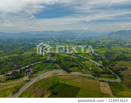 Mountain with hills and green forest. Farmlands and water flowing on river. Mindanao, Philippines. 119953622