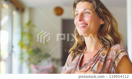 Smiling woman relaxing indoors in natural light 119954112