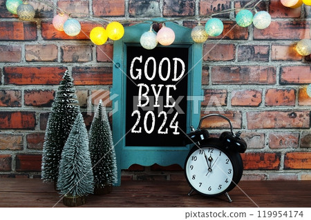 Goodbye 2024 text on blackboard easel stand with alarm clock on wooden and old brick wall background Goodbye 2024 text on blackboard easel stand with alarm clock on wooden and old brick wall background 119954174