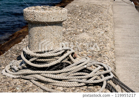 Mooring rope at a pier in the small fishing port of Imabari Minato 119955217