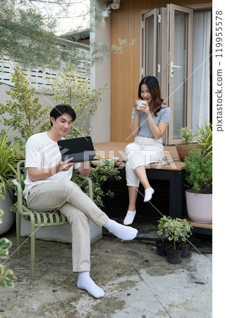 Happy asian couple spending time together in beautiful garden space Happy asian couple spending time together in beautiful garden space 119955578