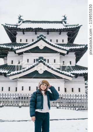 Woman tourist sightseeing Hirosaki Castle in winter, happy traveler travel Hirosaki city, Aomori Prefecture, Tohoku, Japan. Landmark and famous for tourist attraction. Japan travel and vacation Woman tourist sightseeing Hirosaki Castle in winter, happy traveler travel Hirosaki city, Aomori Prefecture, Tohoku, Japan. Landmark and famous for tourist attraction. Japan travel and vacation 119955830