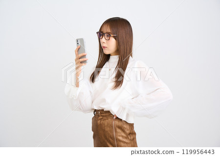 Young woman looking at a smartphone 119956443