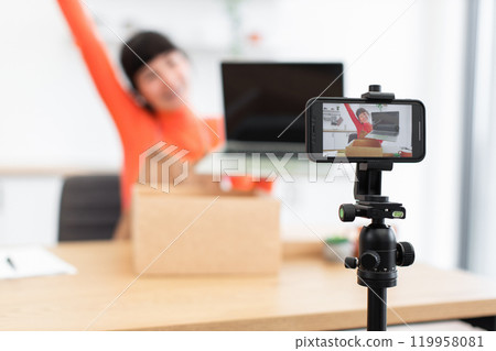 Excited caucasian female blogger unboxing new laptop during live stream Excited caucasian female blogger unboxing new laptop during live stream 119958081