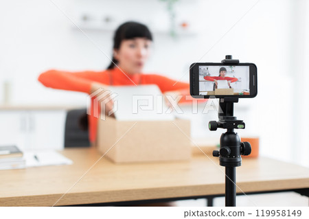 Caucasian female blogger unboxing new digital laptop for online audience Caucasian female blogger unboxing new digital laptop for online audience 119958149