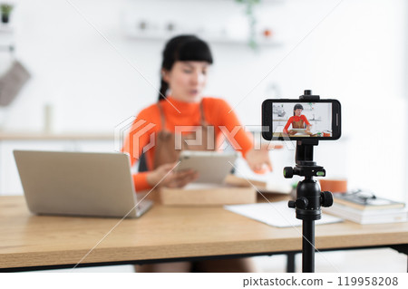 Caucasian female blogger unboxing new digital tablet online 119958208