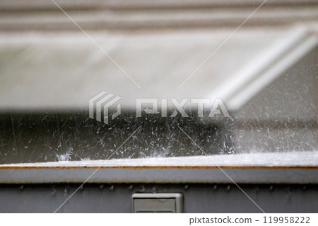 Rainwater falling on an outdoor iron plate 119958222