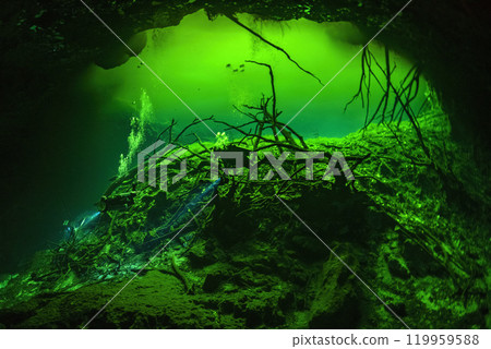 Diving in Mexican Cenote underwater cave with green gas cloud Diving in Mexican Cenote underwater cave with green gas cloud 119959588