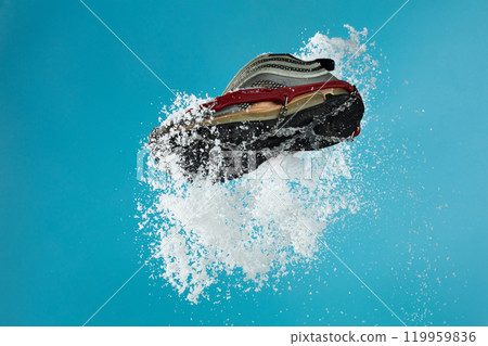 Hiking trail in winter should wear Crampons snow spike on shoes to protect slippery on ice icy surface road. Crampon spike shoe walk good on snow, blue sky background isolated 119959836