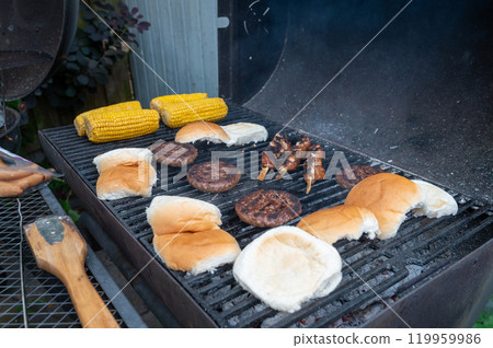 Summertime Backyard Barbecue with Burgers and Corn on the Grill 119959986