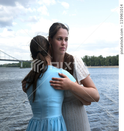 Insincere smile of a hugging girl Insincere smile of a hugging girl 119961014