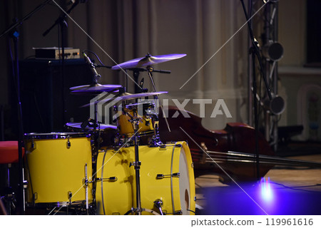 Yellow drum kit musical instrument on stage 119961616