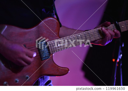 Hands of guitar player playing live on guitar at concert 119961630