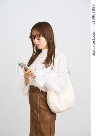 Young woman looking at a smartphone 119961988