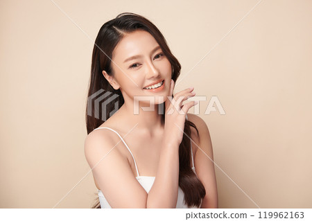 Beautiful young asian woman with clean fresh skin on beige background, Face care, Facial treatment, Cosmetology, beauty and spa, Asian women portrait. 119962163