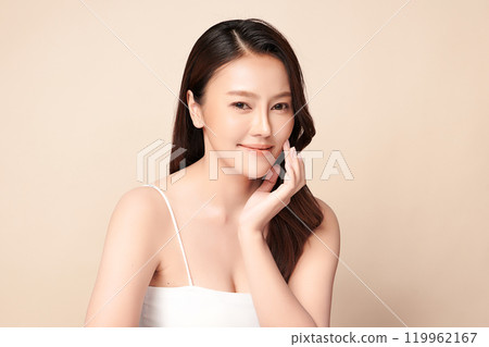 Beautiful young asian woman with clean fresh skin on beige background, Face care, Facial treatment, Cosmetology, beauty and spa, Asian women portrait. 119962167