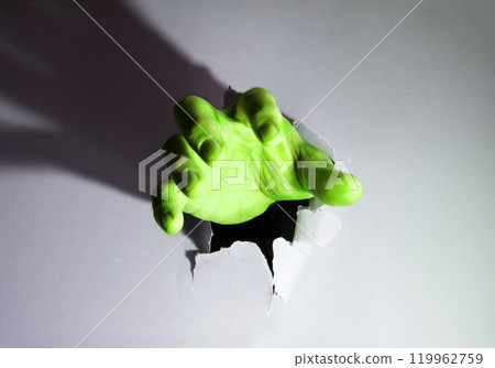 The hand pierced the sheet of paper The hand pierced the sheet of paper 119962759