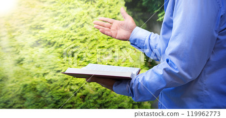 Old man with a bible in his hand Old man with a bible in his hand 119962773