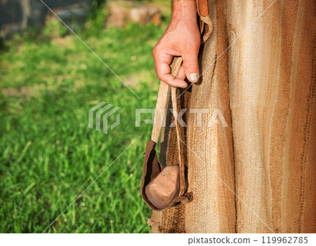 Ancient man with a sling 119962785