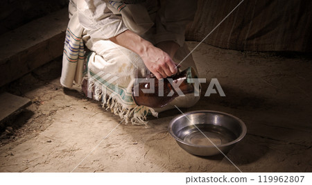 Male slave serve in the house pouring water 119962807