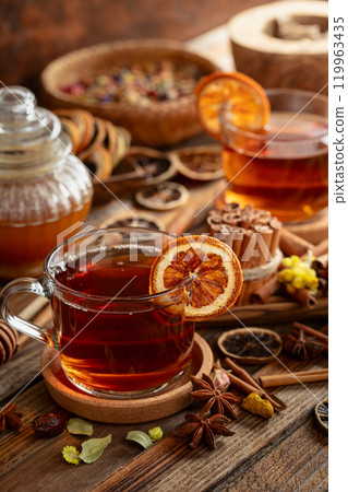 Herbal tea with cinnamon, anise, dried herbs, and dry citrus slices. Herbal tea with cinnamon, anise, dried herbs, and dry citrus slices. 119963435