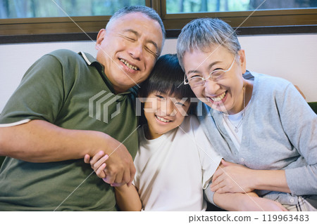 Smiling grandchildren and grandparents standing close together Smiling grandchildren and grandparents standing close together 119963483
