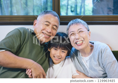 Smiling grandchildren and grandparents standing close together Smiling grandchildren and grandparents standing close together 119963485