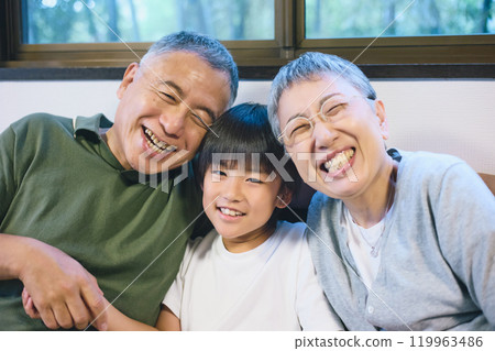 Smiling grandchildren and grandparents standing close together Smiling grandchildren and grandparents standing close together 119963486
