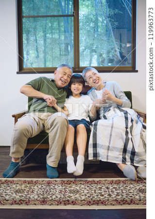 Smiling grandchildren and grandparents standing close together Smiling grandchildren and grandparents standing close together 119963773