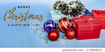 Merry Christmas and Happy New Year Wishes text on blue cover background with Christmas balls and present. Christmas celebration concept 119964622