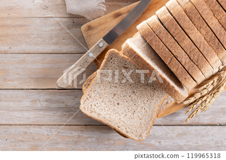 Healthy wholemeal bread slices on rustic wooden table Healthy wholemeal bread slices on rustic wooden table 119965318
