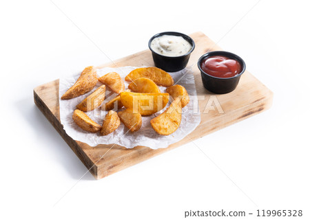 Fried potato wedges with sauces isolated on white background. Fried potato wedges with sauces isolated on white background. 119965328