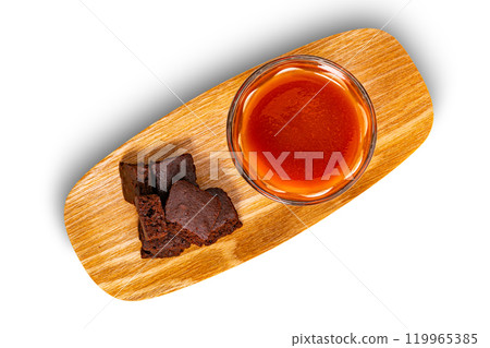 Top view pile of crispy brownie chocolate cube and a glass of tomato juice. 119965385