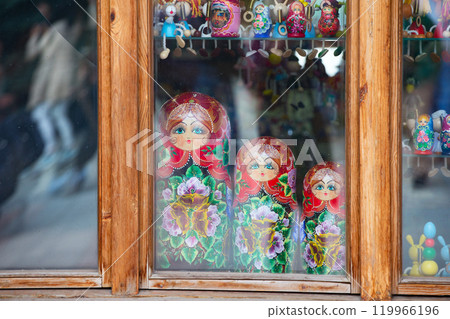 Three dolls of nested dolls behind the glass. Nested dolls. 119966196