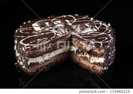 A slice of chocolate cake with coffee beans on a black background 119966228