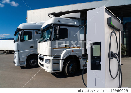 Electric vehicles charging station on a background of a trucks. Concept. Electric vehicles charging station on a background of a trucks. Concept. 119966609