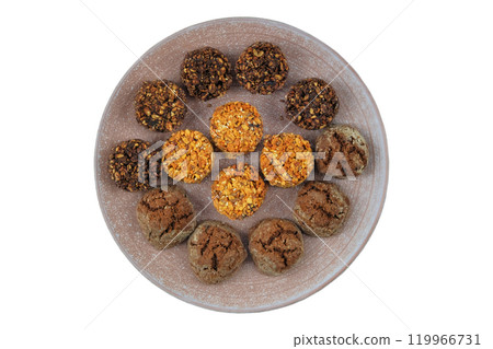 Chocolate and cereal cookies in ceramic plate isolated on a white background. Nutritious baking. Top view. Chocolate and cereal cookies in ceramic plate isolated on a white background. Nutritious baking. Top view. 119966731