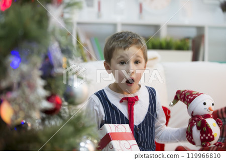 A boy with a Christmas gift.Get a gift for Christmas. The child received a gift A boy with a Christmas gift.Get a gift for Christmas. The child received a gift 119966810