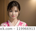 A woman wearing a pink kimono with her hair tied up 119966913