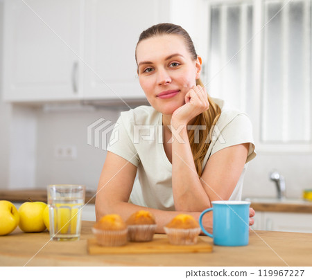 Portrait of young woman drinking morning coffee in modern kitchen 119967227