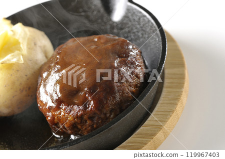 Hot hamburger steak and hot buttered potatoes photographed on a white background Hot hamburger steak and hot buttered potatoes photographed on a white background 119967403