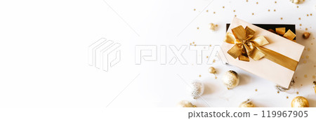 Banner with Christmas gift boxes, adorned with vibrant golden ribbons on white background with shadows 119967905