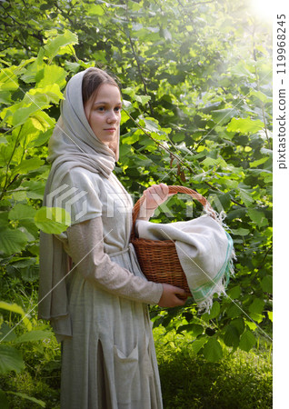 Young girl with basket in the park Young girl with basket in the park 119968245