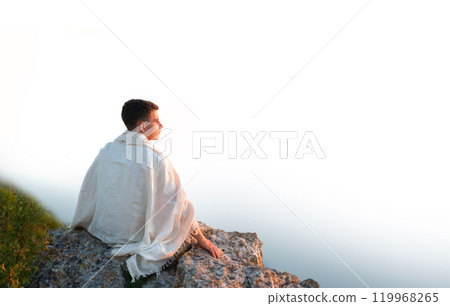 Young man sit on the hill Young man sit on the hill 119968265