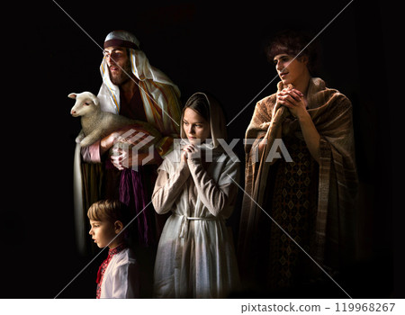 Mary sits in the stable near the manger with the baby 119968267
