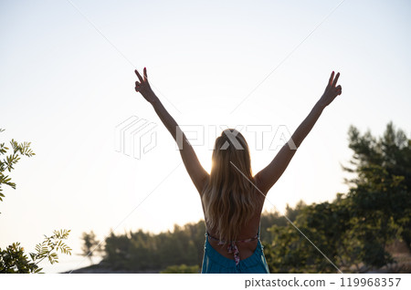 Embracing freedom at sunrise 119968357